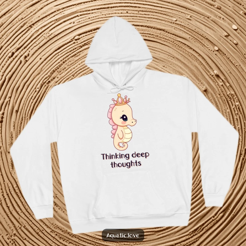 Funny seahorse hoodie showing a curious creature with a tiny seashell crown peering into the distance, offering cozy regal humor.