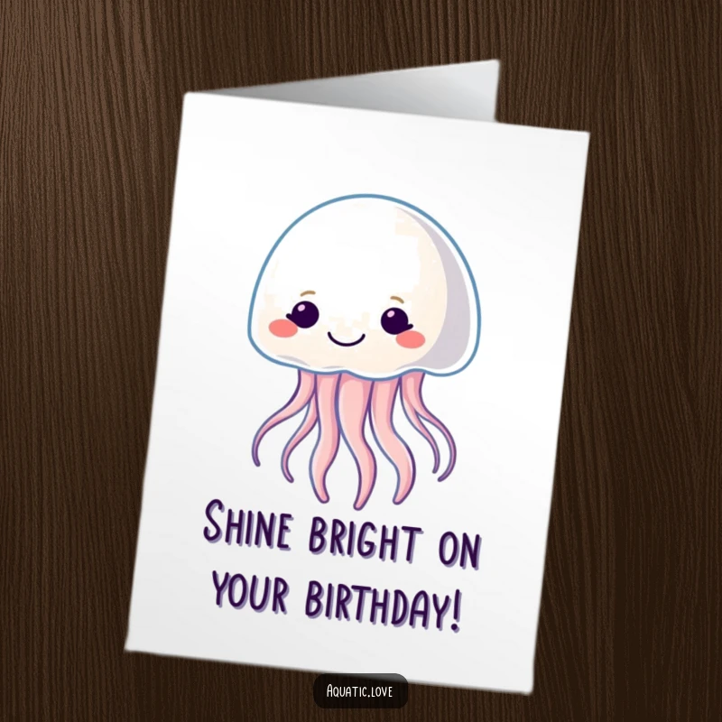 Free Printable Birthday Card: Smiling jellyfish character gently pulsating with soft light, wishing a glowing happy birthday.
