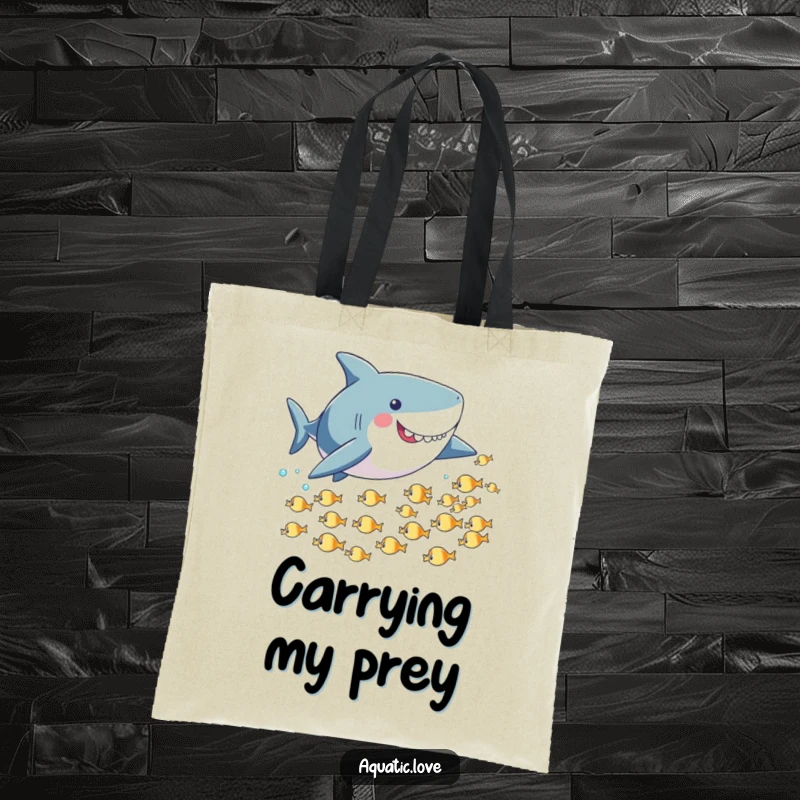 Funny tote bag showcasing a playful shark with small fins playfully chasing tiny fish, perfect for carrying your items with a quirky vibe.
